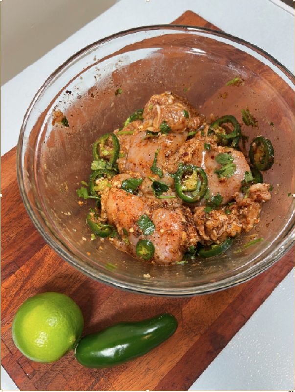 Chicken marinating with jalapeños, cilantro, and lime